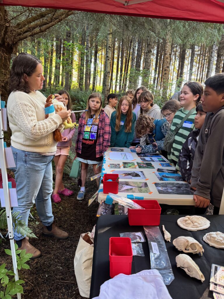 Wildlife Center staff member explaining wildlife rehabilitation to a group of students.